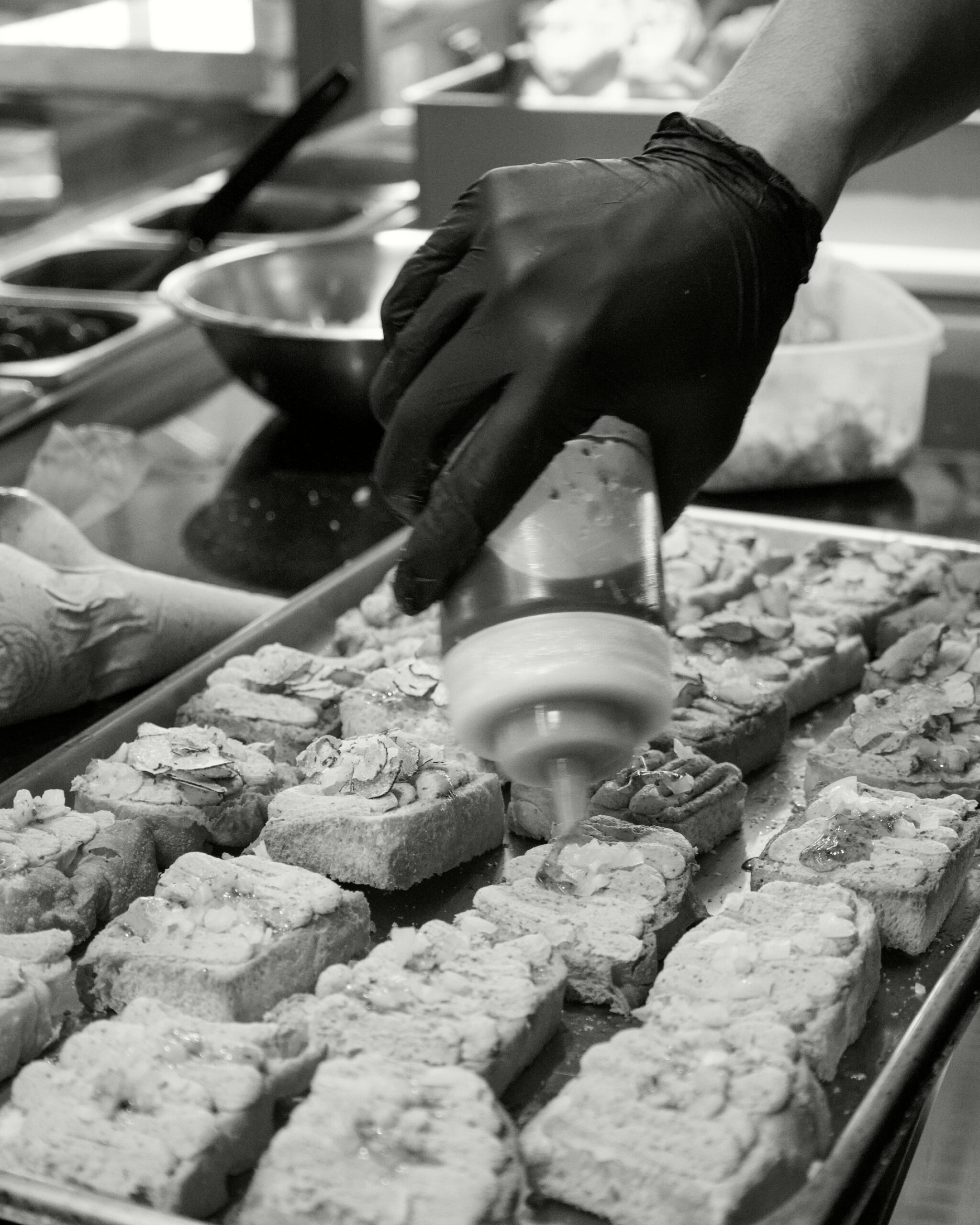 Chef arranging Italian canapés on a tray for a Bianca catering event